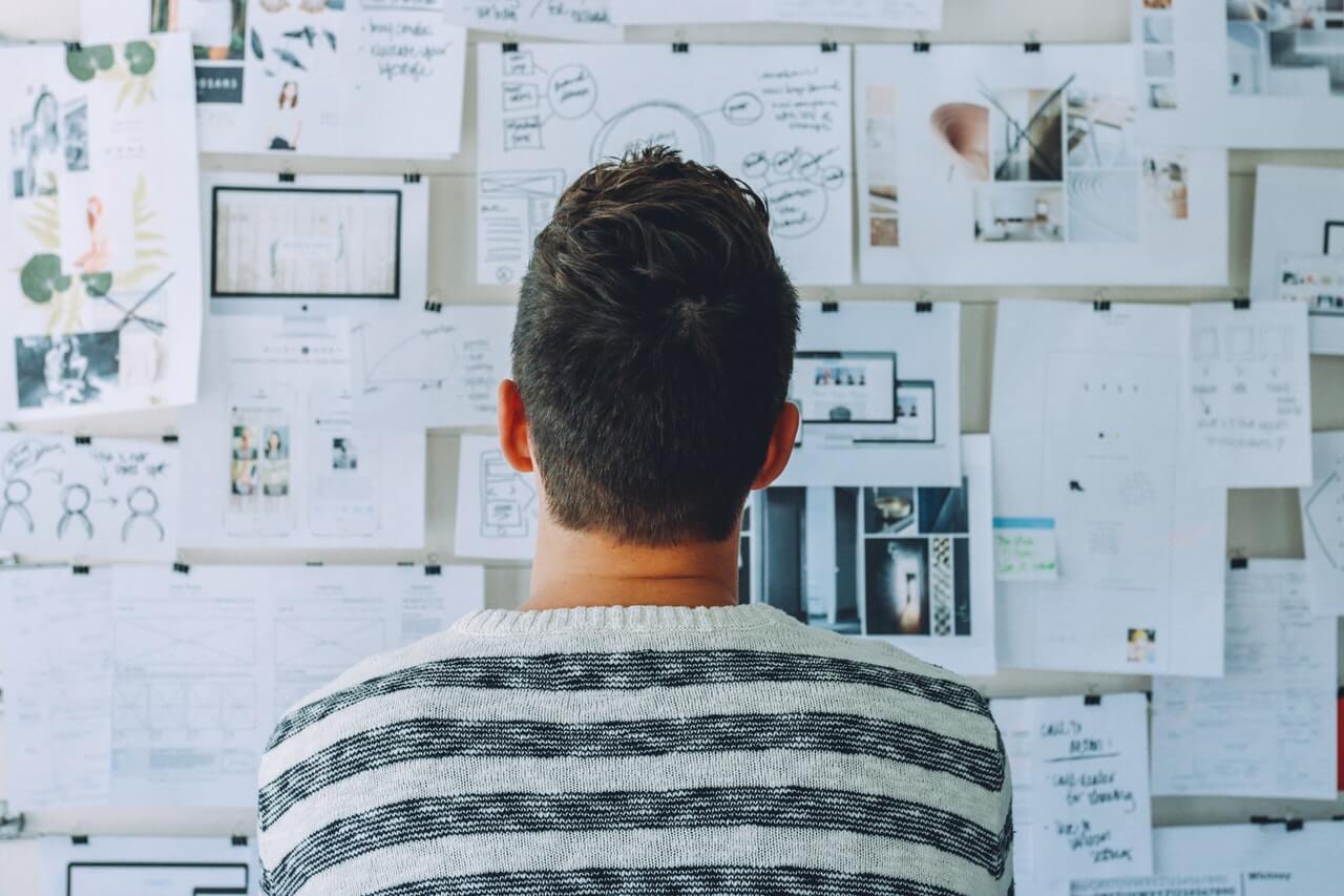 A person looking at a white board Description automatically generated with low confidence