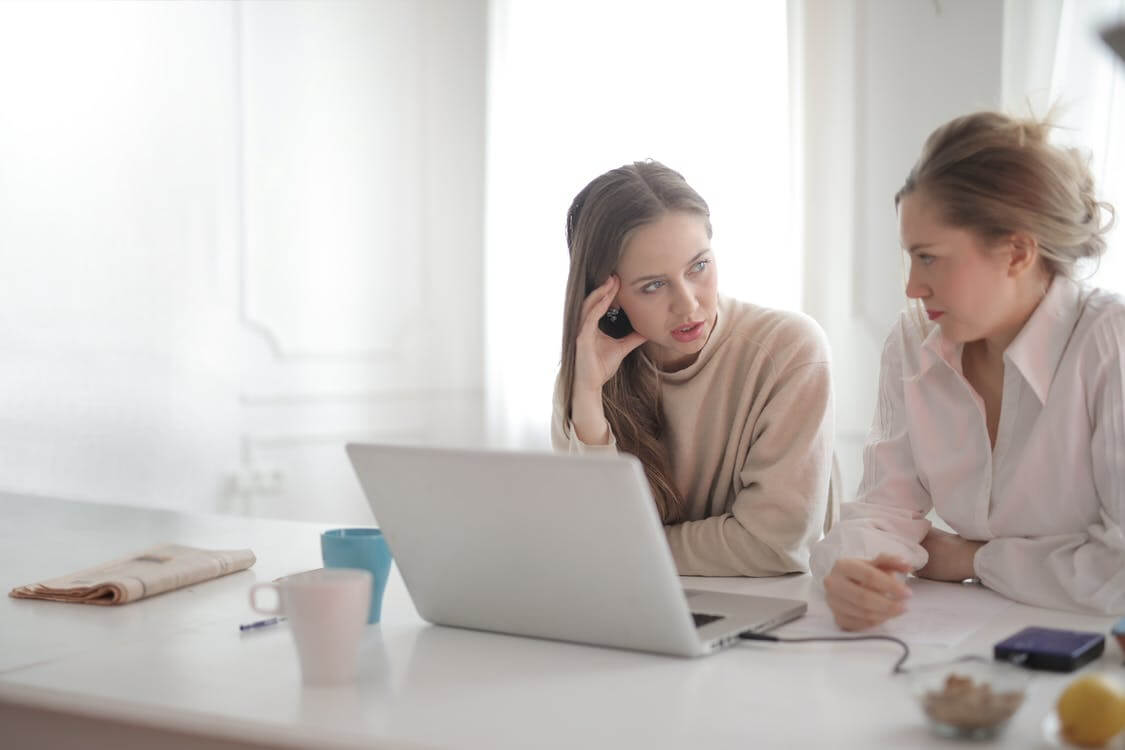 Free Thoughtful coworking women discussing project in home office Stock Photo
