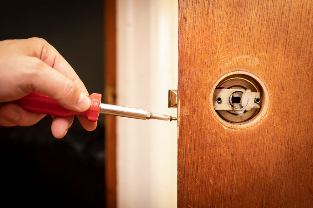 Fixing or replacing a doorknob with a screwdriver