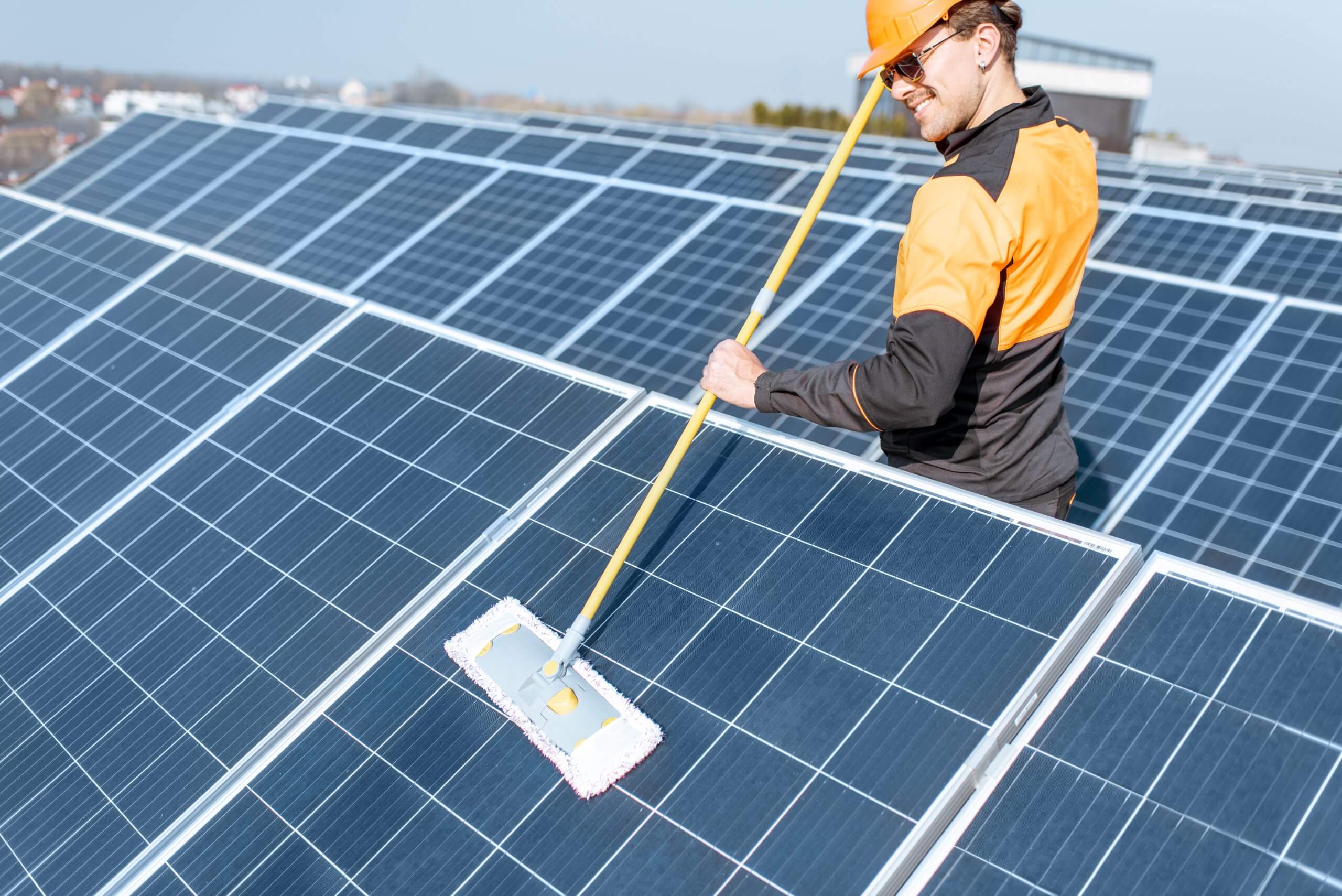 Workman cleaning solar panels