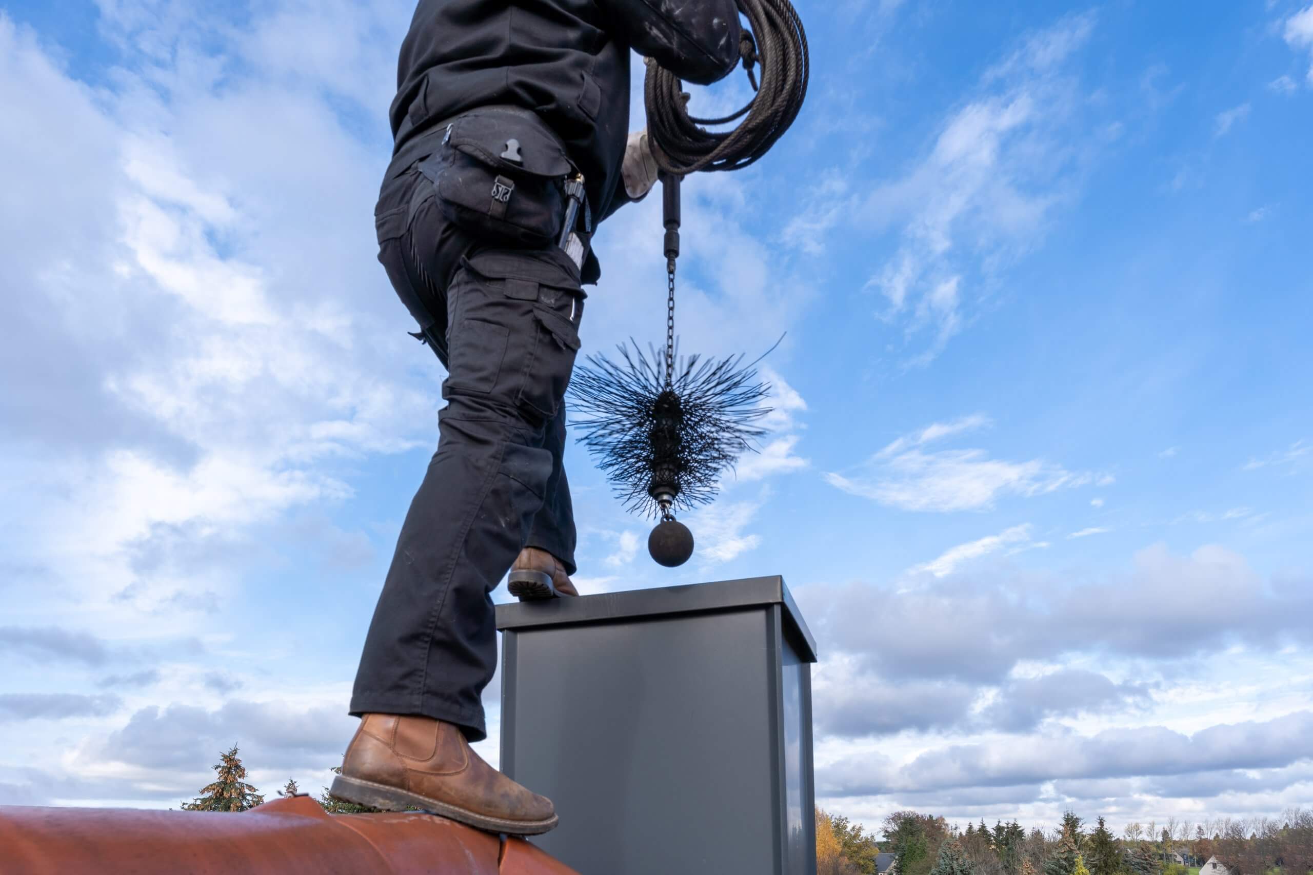 chimney sweep with stovepipe hat upon the roof