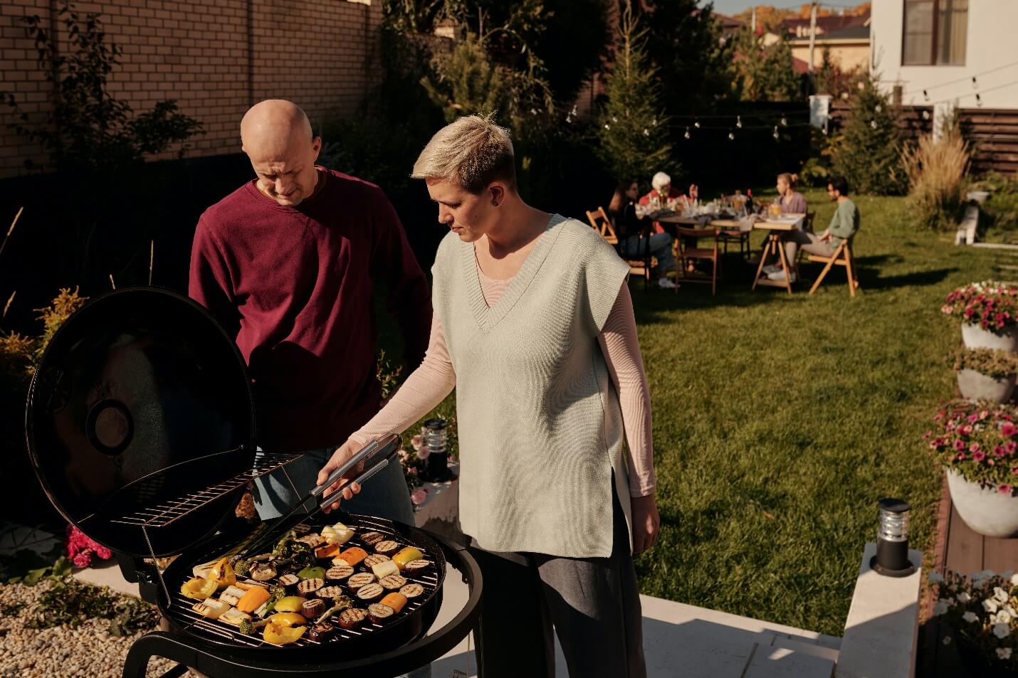 A person and person cooking food on a grill

Description automatically generated with low confidence