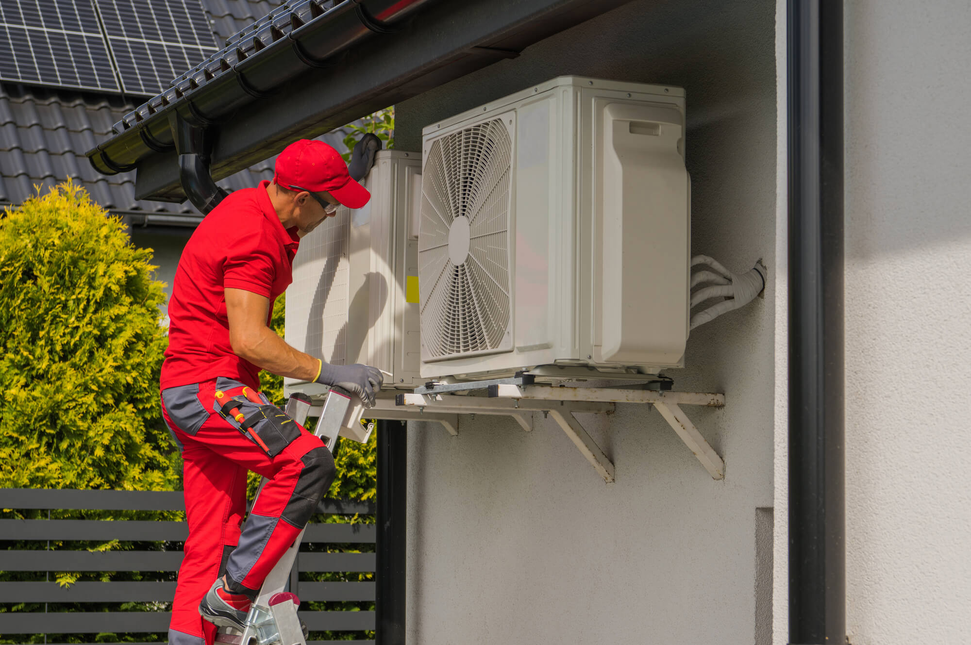 Professional Caucasian HVAC Worker in His 40s Performing Heat Pump and Air Condition Units Seasonal Maintenance