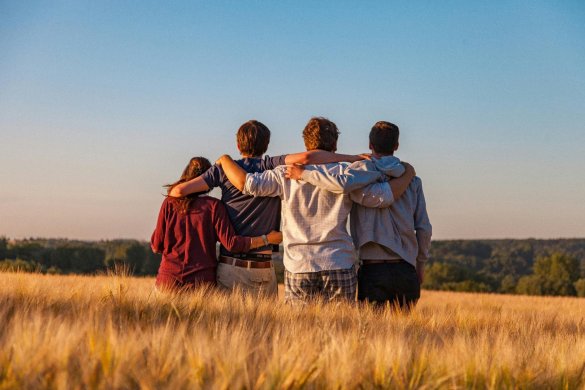 a group of people embracing in a field