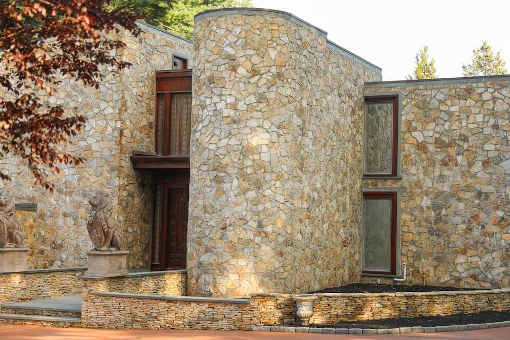 A stone house with a stone statue AI-generated content may be incorrect.