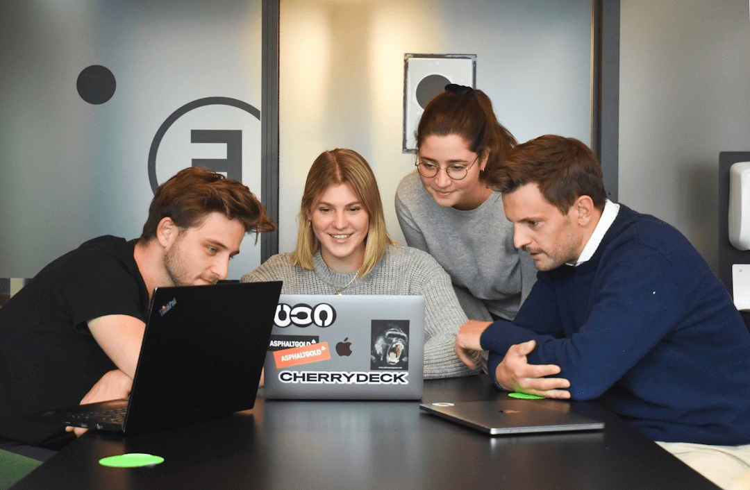 A team of employees working on their computers to enhance customer support through streamlined information access